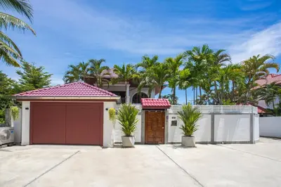 a garage in front of a house with palm trees at Best Holidays - Oxygen pool, Billard, Gym! 2-Storey Tropical Villa Havana N in Kamala Beach
