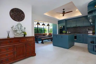 a kitchen with blue cabinets and a ceiling fan at Best Holidays - Oxygen pool, Billard, Gym! 2-Storey Tropical Villa Havana N in Kamala Beach