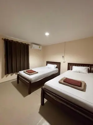a bedroom with two beds and a window at Phi Phi Paradise Hostel in Phi Phi Don