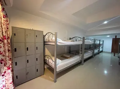 a room with two bunk beds and cabinets in it at Phi Phi Paradise Hostel in Phi Phi Don