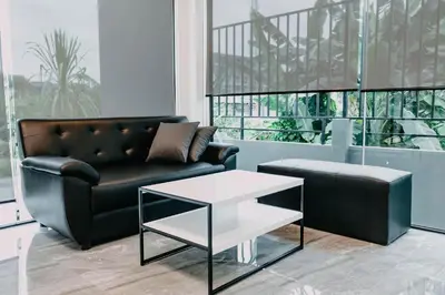 a living room with a couch and a coffee table at De Piraya residence in Mai Khao Beach