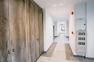 a hallway with a wooden door in a room at De Piraya residence in Mai Khao Beach