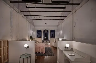 a large room with a bed and a table at 97 Yaowarat - Phuket Old Town in Phuket Town