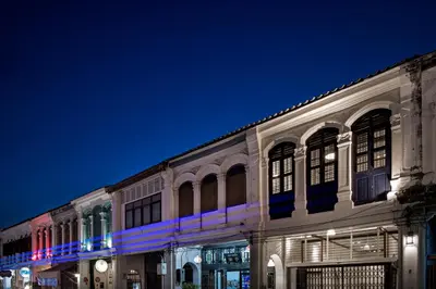 a building with blue lights on the side of it at 97 Yaowarat - Phuket Old Town in Phuket Town