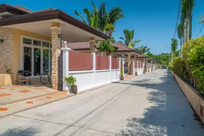 a street in a house with a white fence at Rawai Private Villas - Pools and Garden in Rawai Beach