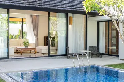 a villa with a swimming pool and a house at Anchan Villas Phuket - Private 2 Bedroom Pool Villas by Escape Villas in Bang Tao Beach