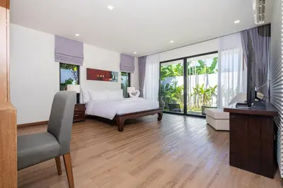 a bedroom with a bed and a television in it at Anchan Villas Phuket - Private 2 Bedroom Pool Villas by Escape Villas in Bang Tao Beach
