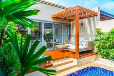 a wooden deck with a bench and a chair on a house at The residence resort Villa 1bdr Private Pool in Phuket Town