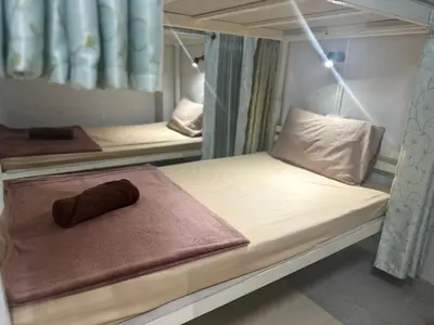a room with two bunk beds with a brown towel at PhiPhi Film House in Phi Phi Don