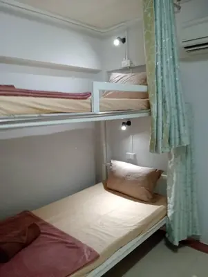 a small room with two bunk beds in it at PhiPhi Film House in Phi Phi Don