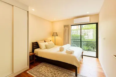 a bedroom with a bed and a large window at The Title Rawai Beachfront (Sea paradise) in Rawai Beach