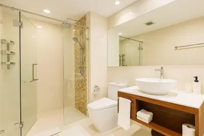 a bathroom with a sink and a toilet and a shower at The Title Rawai Beachfront (Sea paradise) in Rawai Beach