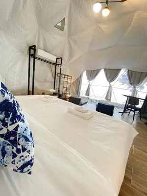 a white bed in a tent with windows at Touch Glamping Koh Yao Noi ทัช แกรมปิ้ง เกาะยาวน้อย in Ko Yao Noi