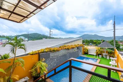 a view from the balcony of a house with a swimming pool at The Cheetar Hotel in Amphoe Kathu