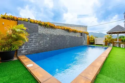 a swimming pool in the backyard of a house at The Cheetar Hotel in Amphoe Kathu