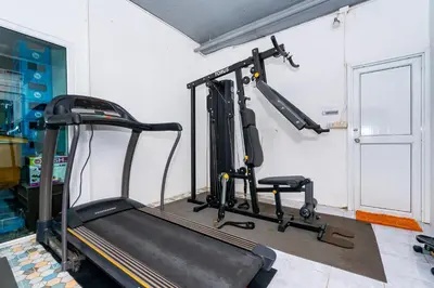 a gym with a treadmill in a room at The Cheetar Hotel in Amphoe Kathu