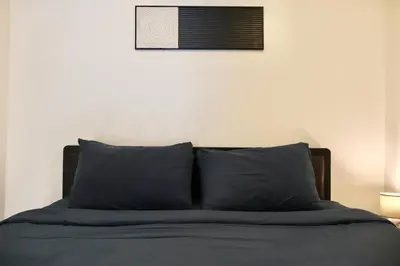 a bed with blue pillows in a bedroom at Chonlada Holiday Home - 2 BR Pool Access Bungalow - Kamala Beach in Kamala Beach