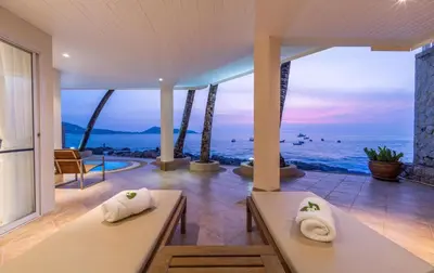 a living room with a view of the ocean at Beachfront Kalim Beach Villa in Patong Beach