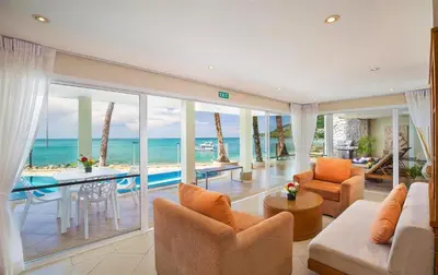 a living room with a view of the ocean at Beachfront Kalim Beach Villa in Patong Beach