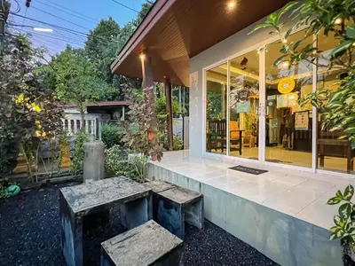 a house with a bench in front of it at Naiyang Boutique Resort in Ban Phak Chit