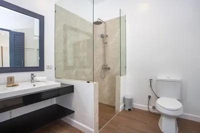 a bathroom with a shower and a toilet and a sink at Villa Elima. Lovely pool villa 2 bedrooms at Rawai in Rawai Beach