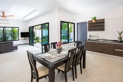 a kitchen and dining room with a table and chairs at Villa Elima. Lovely pool villa 2 bedrooms at Rawai in Rawai Beach