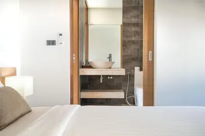a bathroom with a sink and a sink at Eden Escape Naiyang Beach in Phuket Town