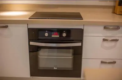 a kitchen with a black oven in a counter at Poly Villa Naya 3 in Rawai Beach