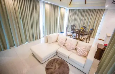 a living room with a white couch and a table at Poly Villa Naya 3 in Rawai Beach