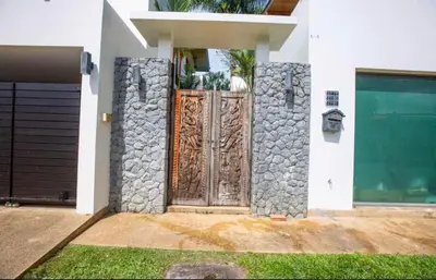 a entrance to a house with a wooden door at Poly Villa Naya 3 in Rawai Beach