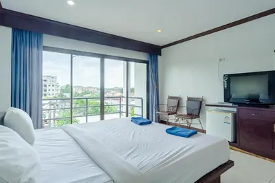 a bedroom with a bed and a large window at Goodday Kathu in Kathu