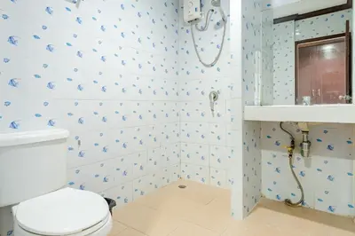 a bathroom with a toilet and a sink at Goodday Kathu in Kathu