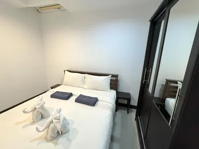 two stuffed animals sitting on a bed in a room at Patong Tower apartment by Lofty in Patong Beach