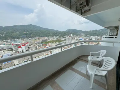 a balcony with two chairs and a view of a city at Patong Tower apartment by Lofty in Patong Beach