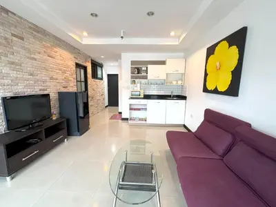 a living room with a purple couch and a tv at Patong Tower apartment by Lofty in Patong Beach