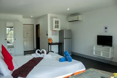 a bedroom with a white bed with bows on it at Deng's kamala beach Guesthouse in Kamala Beach