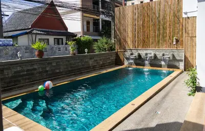 a swimming pool with a ball in the water at Deng's kamala beach Guesthouse in Kamala Beach