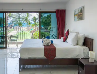 a bedroom with a bed with a stuffed animal on it at Deng's kamala beach Guesthouse in Kamala Beach
