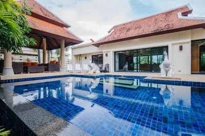 a villa with a swimming pool and a house at Lotus Pool Villa Your Own Slice Of Island Paradise in Rawai Beach