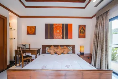 a bedroom with a bed and a desk and a window at Lotus Pool Villa Your Own Slice Of Island Paradise in Rawai Beach