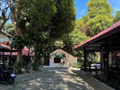 a white building with a tree in front of it at Pagi Pagi villas in Ao Nang Beach