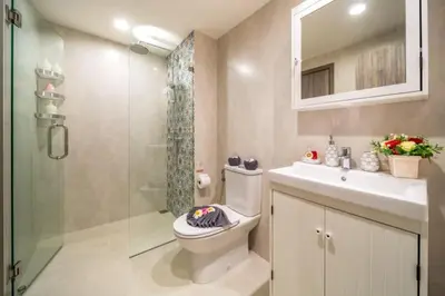 a bathroom with a toilet and a shower and a sink at Title НайЯнг NaiYang in Nai Yang Beach
