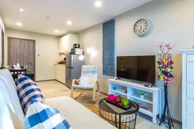 a living room with a couch and a television at Title НайЯнг NaiYang in Nai Yang Beach