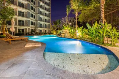a swimming pool in front of a building at Title НайЯнг NaiYang in Nai Yang Beach