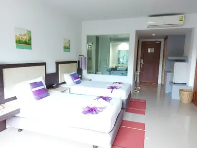 a living room with two beds and a couch at AM Surin Place in Surin Beach