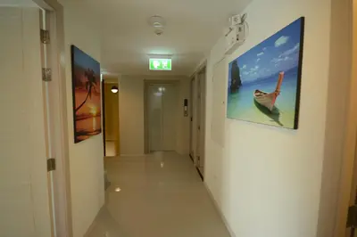 a hallway in a hospital with a painting on the wall at The Patong Center Hotel in Patong Beach