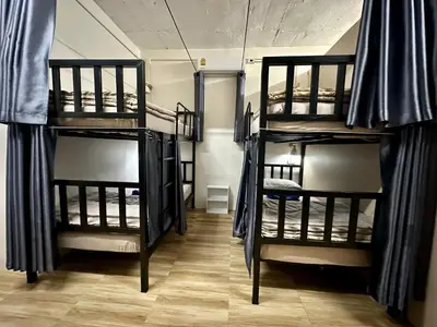 a room with three bunk beds in a room at Sweed Dee Hostel in Phi Phi Don