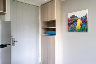 a room with a closet with a painting on the wall at Tropical Living Surin Beach Phuket in Surin Beach