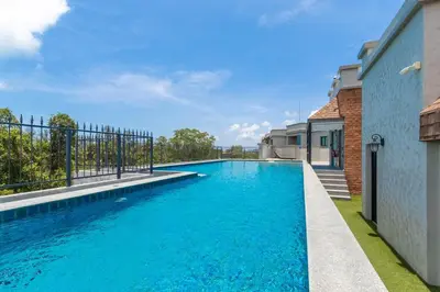 a swimming pool in the backyard of a house at Title Naiyang residence Excellent location with pool view in Nai Yang Beach