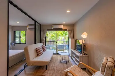 a living room with a couch and a chair and a tub at Title Naiyang residence Excellent location with pool view in Nai Yang Beach